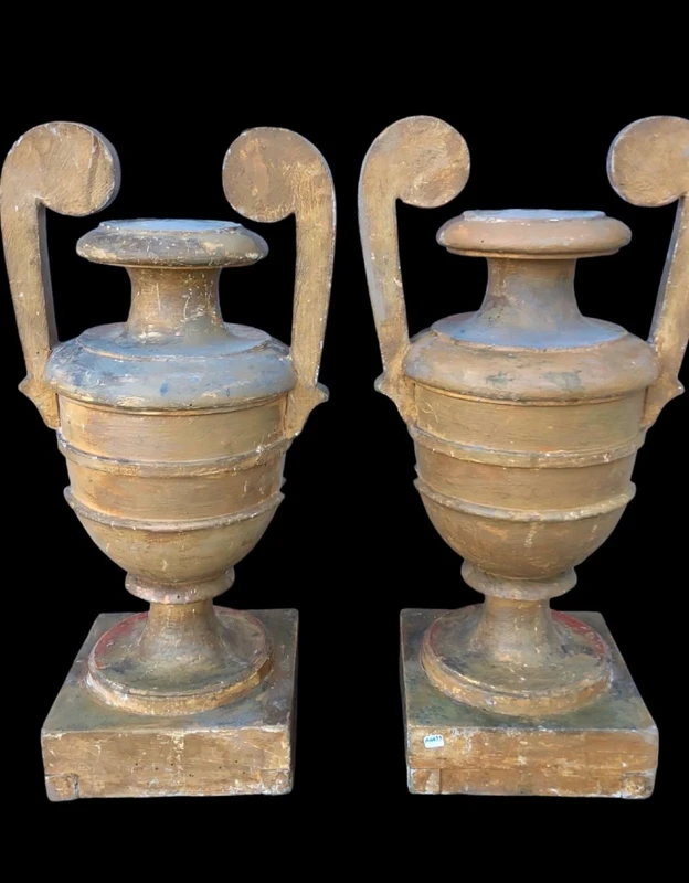 A pair of neoclassical palm-shaped candleholders made of gilded wood with stylized leaf motifs.