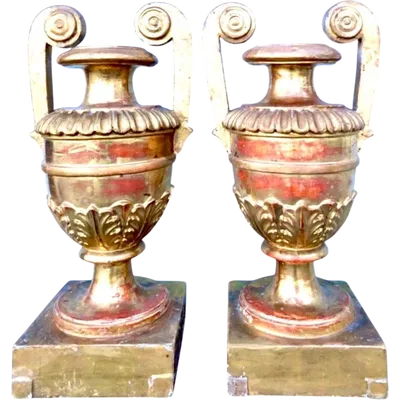 A pair of neoclassical palm-shaped candleholders made of gilded wood with stylized leaf motifs.