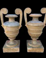 A pair of neoclassical palm-shaped candleholders made of gilded wood with stylized leaf motifs.