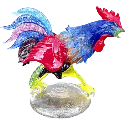 A rooster made of heavy, multicolored glass with gold leaf inlay.