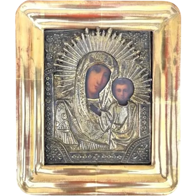 An icon depicting the Virgin and Child, with a painted face and a silver-leaf frame.