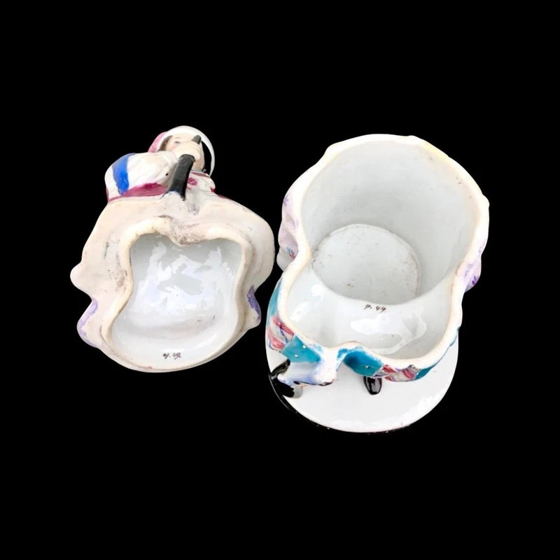 Porcelain tobacco box featuring a female figure with a rifle and a drum.