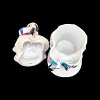 Porcelain tobacco box featuring a female figure with a rifle and a drum.