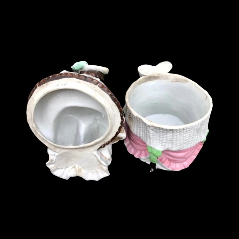 Porcelain tobacco box featuring a seated female figure holding a cigar.