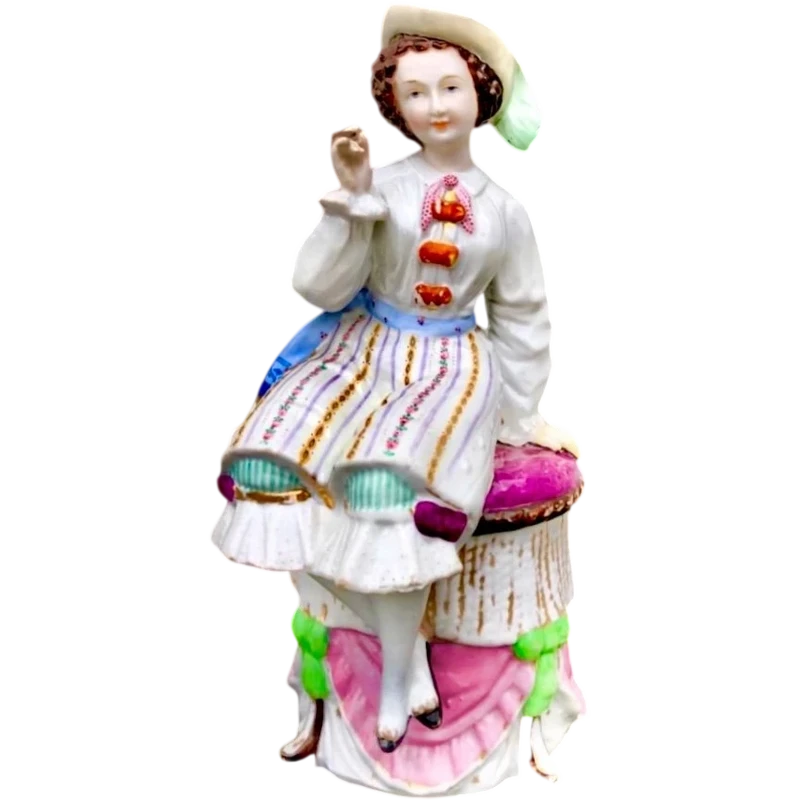 Porcelain tobacco box featuring a seated female figure holding a cigar.