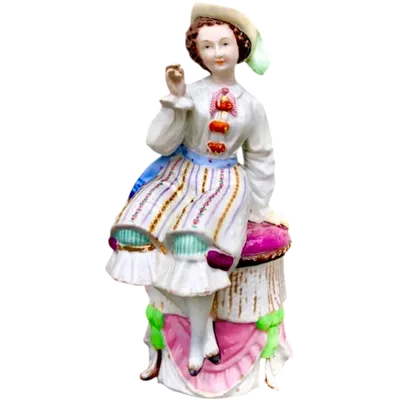 Porcelain tobacco box featuring a seated female figure holding a cigar.