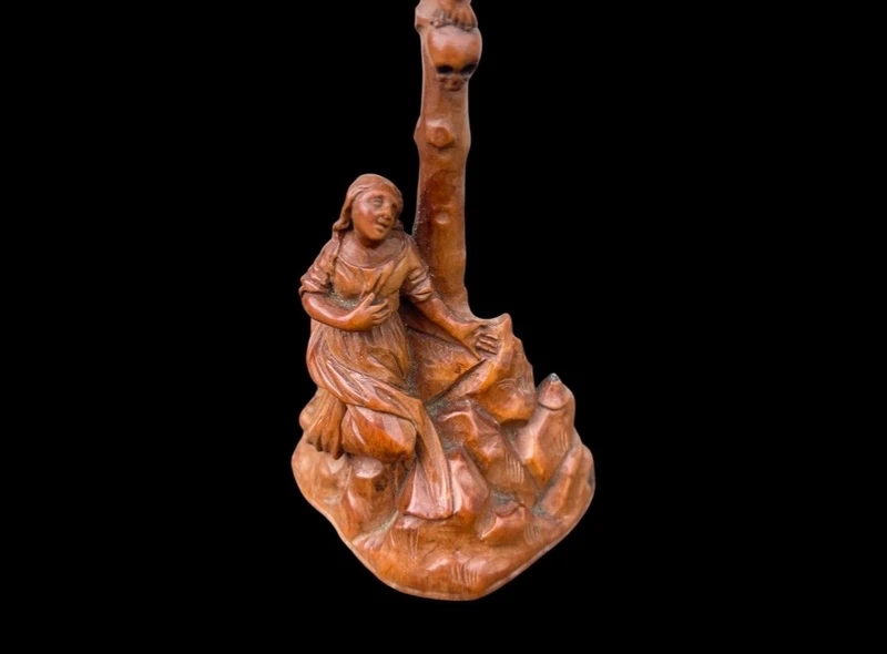 A small boxwood sculpture depicting Christ on the Cross and Mary Magdalene.