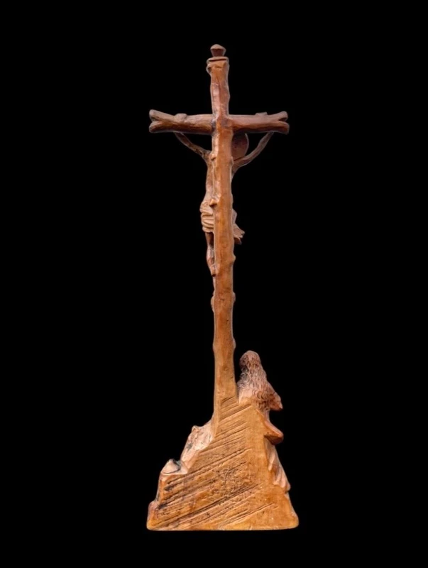 A small boxwood sculpture depicting Christ on the Cross and Mary Magdalene.