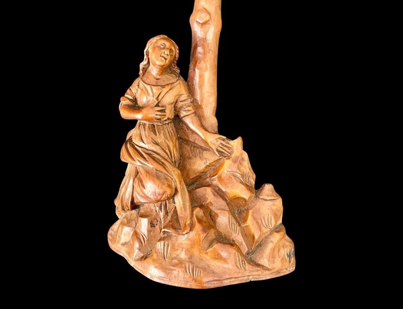 A small boxwood sculpture depicting Christ on the Cross and Mary Magdalene.