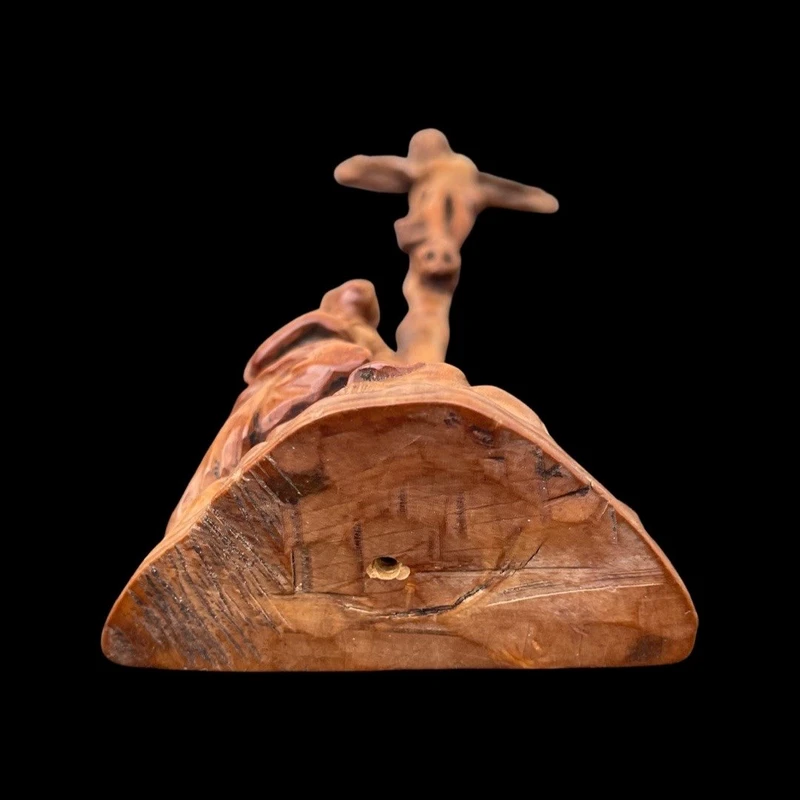 A small boxwood sculpture depicting Christ on the Cross and Mary Magdalene.