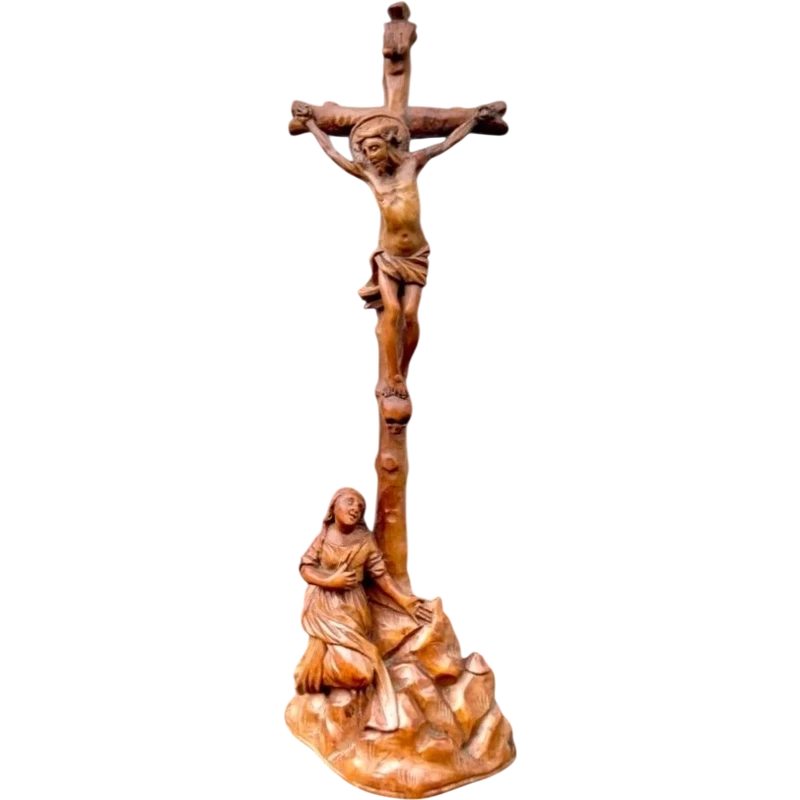 A small boxwood sculpture depicting Christ on the Cross and Mary Magdalene.