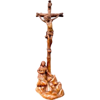 A small boxwood sculpture depicting Christ on the Cross and Mary Magdalene.