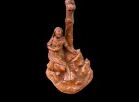 A small boxwood sculpture depicting Christ on the Cross and Mary Magdalene.