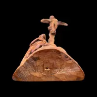 A small boxwood sculpture depicting Christ on the Cross and Mary Magdalene.
