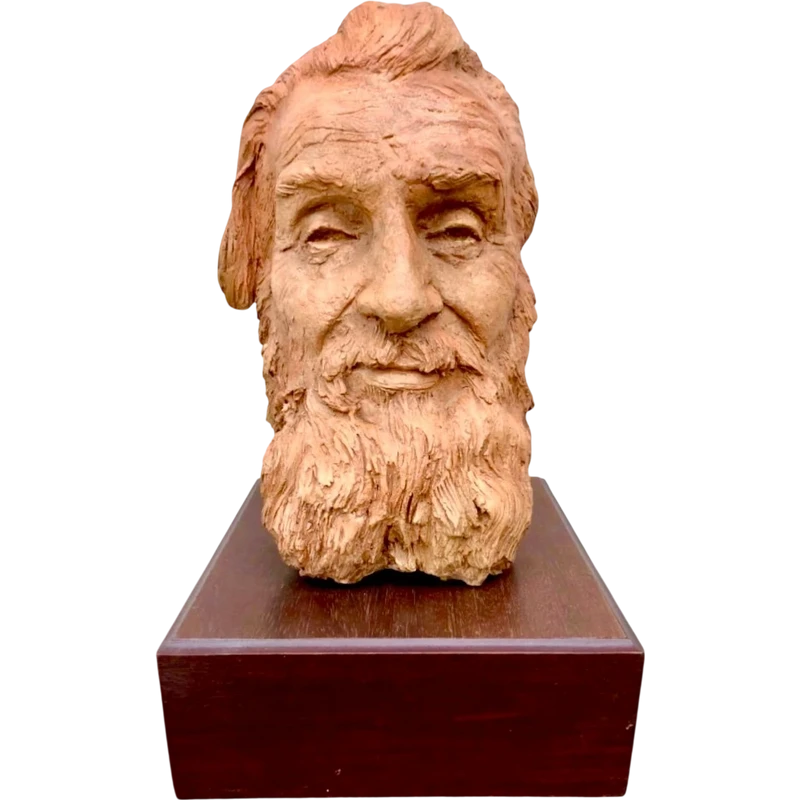 Terracotta sculpture depicting the head of a bearded man. Wooden base.