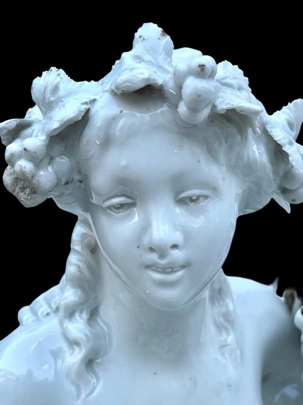 Large porcelain sculpture (masso bastardo) depicting a faun and a nymph with a cherub