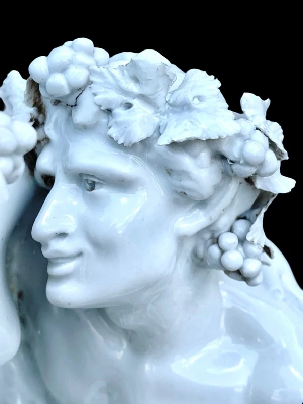 Large porcelain sculpture (masso bastardo) depicting a faun and a nymph with a cherub