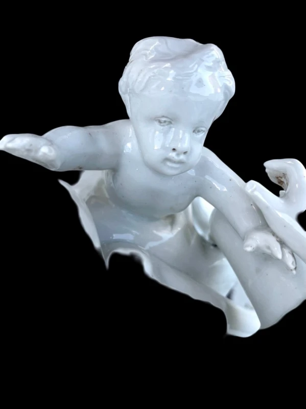 Large porcelain sculpture (masso bastardo) depicting a faun and a nymph with a cherub
