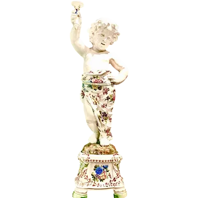 A pair of large majolica candlesticks featuring cherubs and polychrome floral decoration.