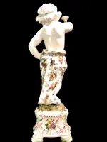A pair of large majolica candlesticks featuring cherubs and polychrome floral decoration.