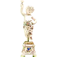 A pair of large majolica candlesticks featuring cherubs and polychrome floral decoration.