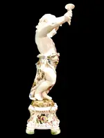 A pair of large majolica candlesticks featuring cherubs and polychrome floral decoration.