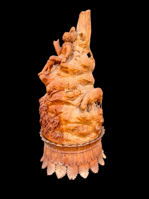 A softwood sculpture depicting a shepherd with sheep