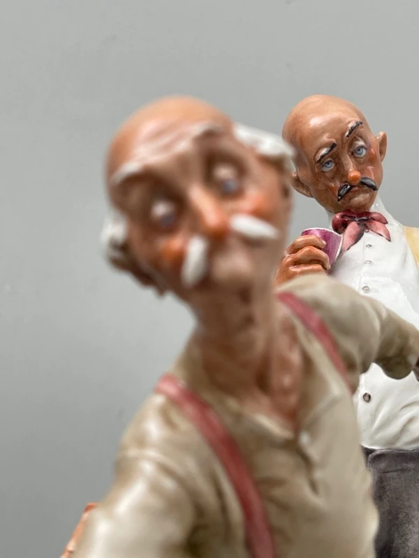 A caricature-style porcelain sculpture depicting bocce players.
