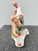 A caricature-style porcelain sculpture depicting bocce players.