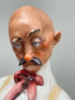 A caricature-style porcelain sculpture depicting bocce players.