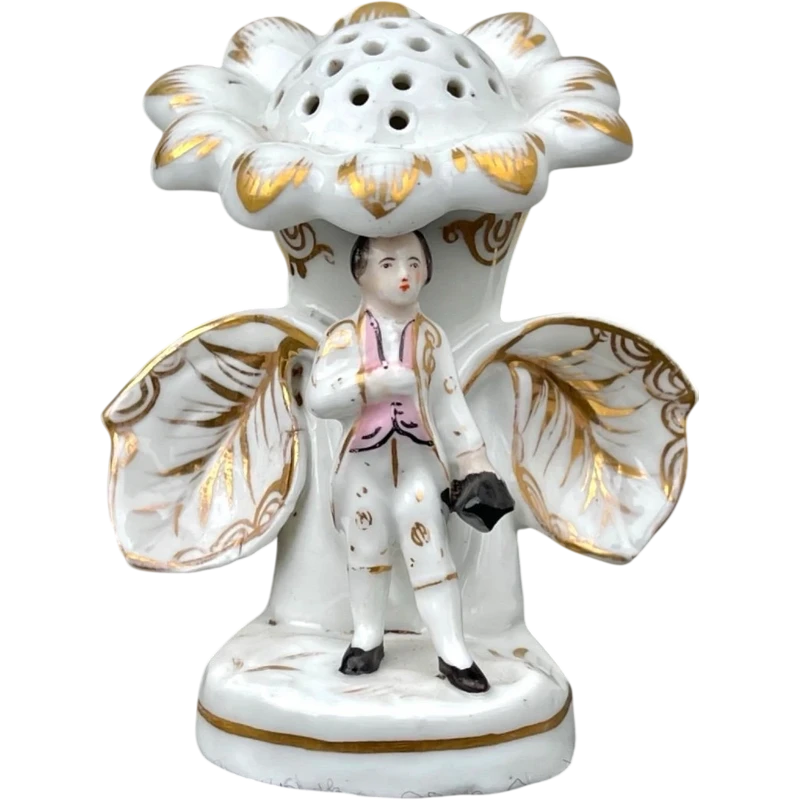 Polychrome porcelain toothpick holder featuring a male figure and shaped like a flower.