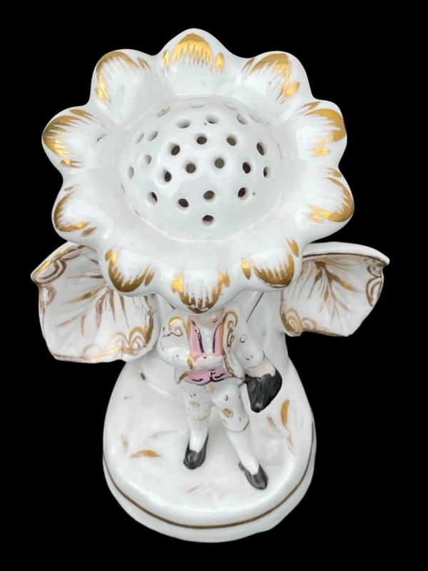 Polychrome porcelain toothpick holder featuring a male figure and shaped like a flower.