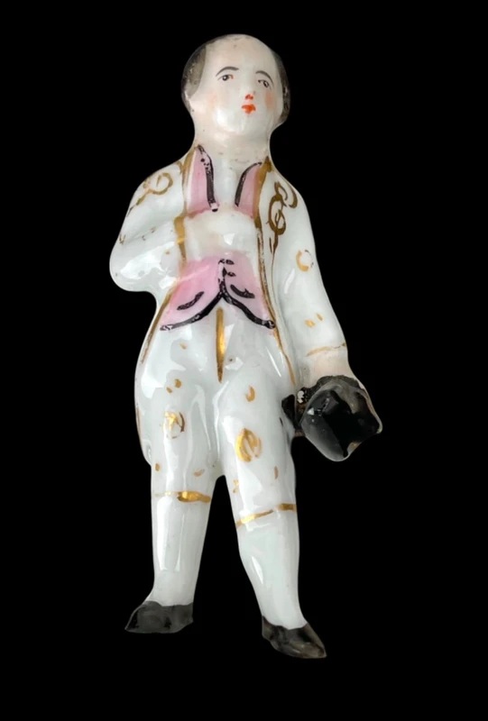 Polychrome porcelain toothpick holder featuring a male figure and shaped like a flower.