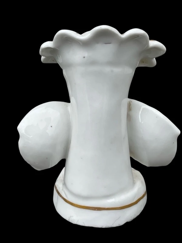 Polychrome porcelain toothpick holder featuring a male figure and shaped like a flower.