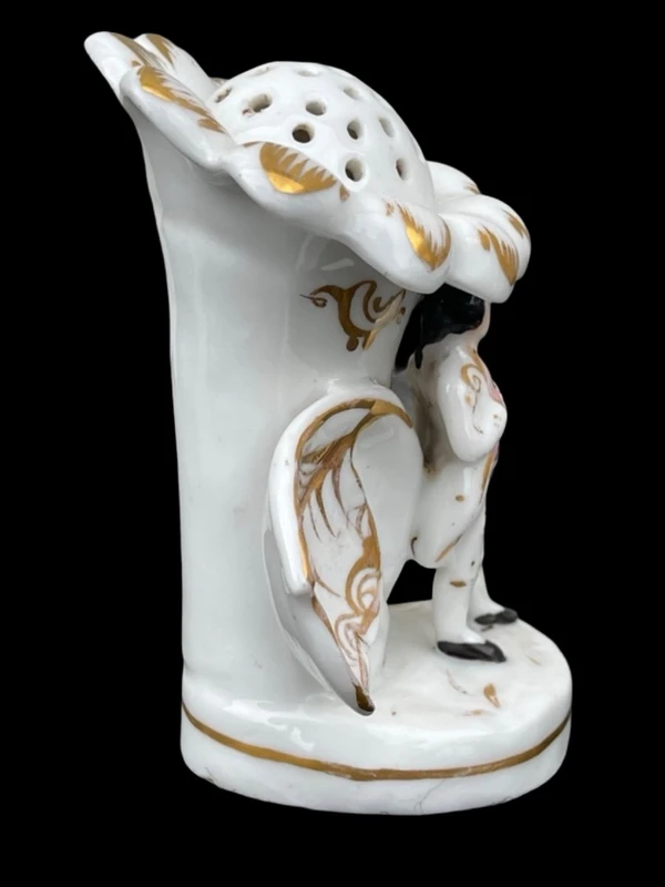 Polychrome porcelain toothpick holder featuring a male figure and shaped like a flower.