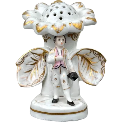 Polychrome porcelain toothpick holder featuring a male figure and shaped like a flower.