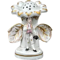 Polychrome porcelain toothpick holder featuring a male figure and shaped like a flower.