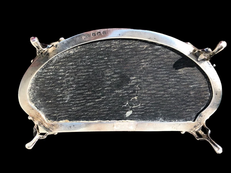 A silver box with a four-legged tortoise design and Art Nouveau floral inlays.