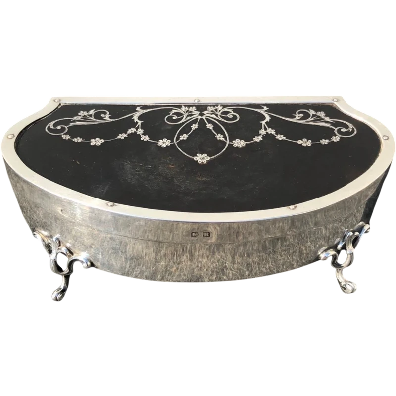 A silver box with a four-legged tortoise design and Art Nouveau floral inlays.