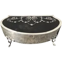 A silver box with a four-legged tortoise design and Art Nouveau floral inlays.