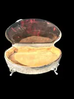 A silver box with a four-legged tortoise design and Art Nouveau floral inlays.
