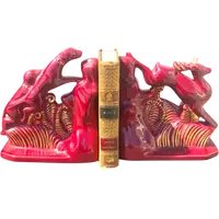A pair of earthenware bookends depicting dogs chasing a deer.