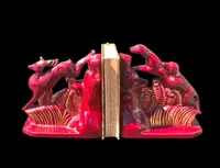 A pair of earthenware bookends depicting dogs chasing a deer.