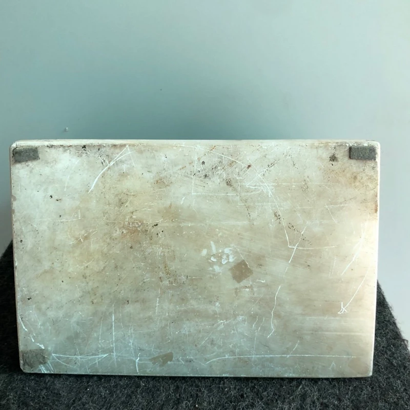 Bronze lion on an alabaster base.