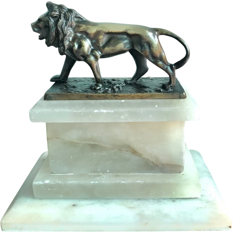 Bronze lion on an alabaster base.