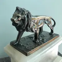 Bronze lion on an alabaster base.