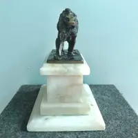Bronze lion on an alabaster base.