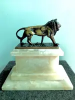 Bronze lion on an alabaster base.