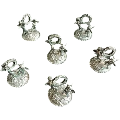 A set of six silver place cards featuring a pair of cherubs holding a garland.
