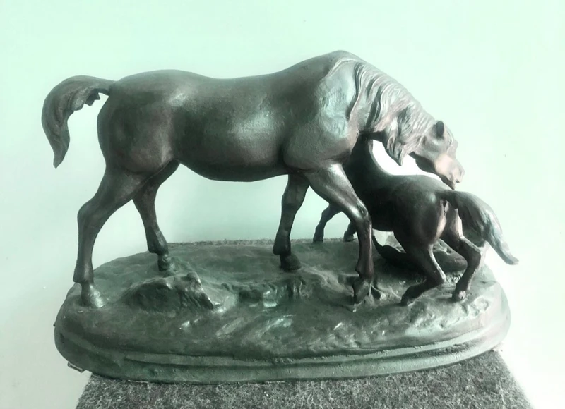 Bronze sculpture depicting a mare with her foal